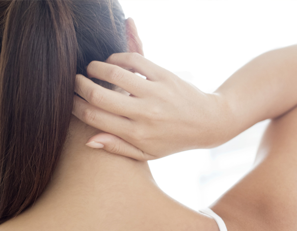 Woman scratching back of her scalp