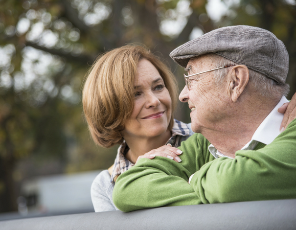 Middle-aged woman acting as a caregiver for her senior father