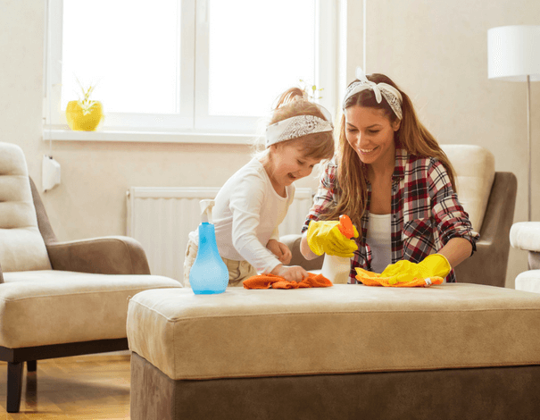 Mother and her toddler daugther cleaning the house