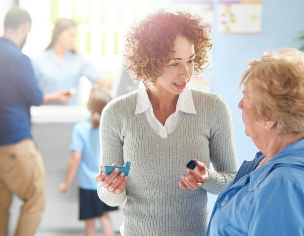 2 woman discussing inhaled medication 2 woman discussing inhaled medication